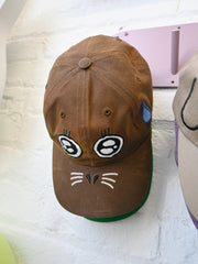 "ARGH-ARGH/SEAL" embroidered Cap design by Natali Koromoto. Made by Ho Hos Hole in The Wall. Waxed 100% cotton. Made in NYC.