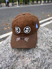 "ARGH-ARGH/SEAL" embroidered Cap design by Natali Koromoto. Made by Ho Hos Hole in The Wall. Waxed 100% cotton. Made in NYC.