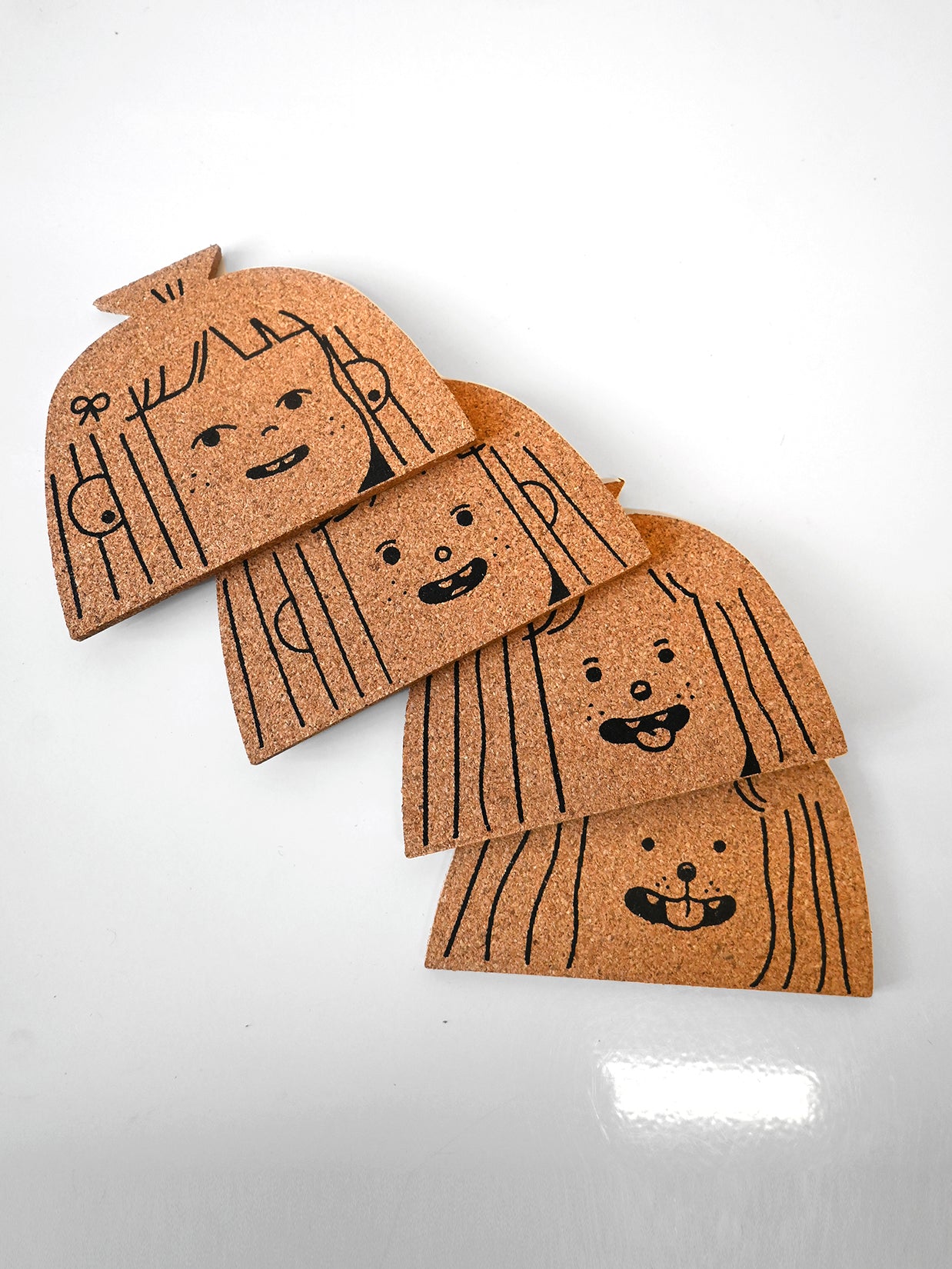 "Dog Person" set of four cork coasters. Design by illustrator Natalí Koromoto Martínez.
