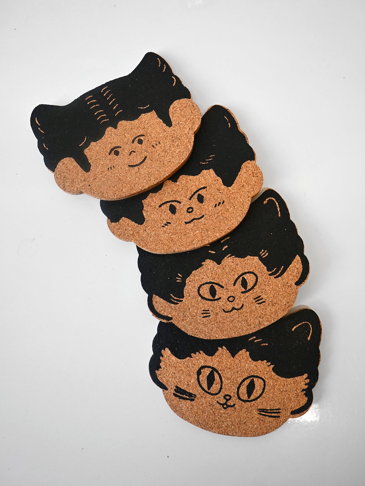 "Cat Person" set of four cork coasters. Design by illustrator Natalí Koromoto Martínez.