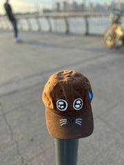 "ARGH-ARGH/SEAL" embroidered Cap design by Natali Koromoto. Made by Ho Hos Hole in The Wall. Waxed 100% cotton. Made in NYC.