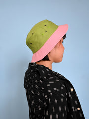 Natali Koromoto x HO HOS HOLE IN THE WALL brand "Ants on Your Hat" printed bucket hat in Avocado Green and True Pink dye colorway combo