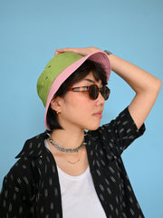 Natali Koromoto x HO HOS HOLE IN THE WALL brand "Ants on Your Hat" printed bucket hat in Avocado Green and True Pink dye colorway combo