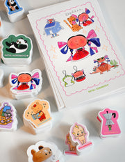 Pack of 10 vinyl stickers, Sticky Friends Edition #4. Designs by Natali Koromoto.
Includes one 4" x 6" postcard.