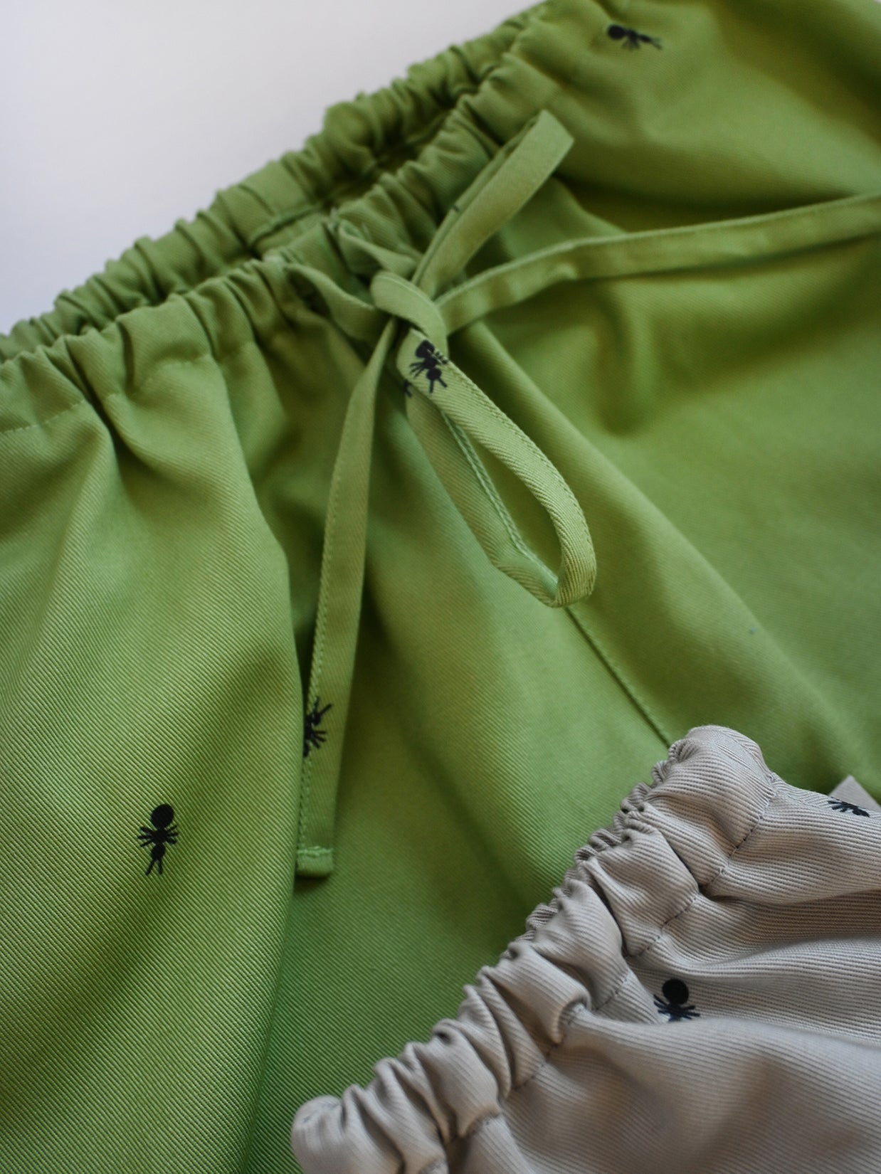 Natali Koromoto x HO HOS HOLE IN THE WALL brands "Ants on Your Pants"  print design lounge pull-on pants in Avocado green dye colorway. 100% organic cotton twill.