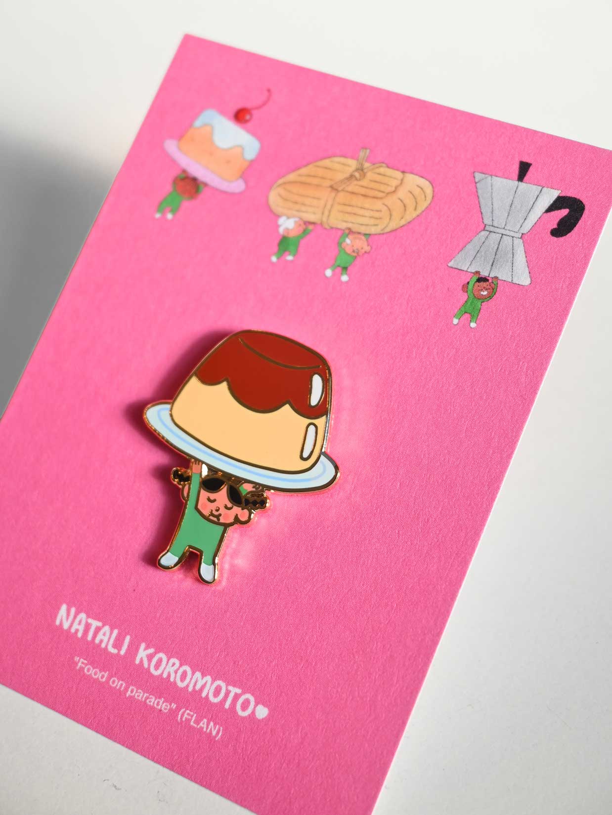 "Food on Parade" (Flan) Enamel Pin. Design by Natali Koromoto Martinez (NYC)