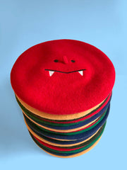 "Sharptooth" embroidered design beret, by Natali Koromoto Martinez.