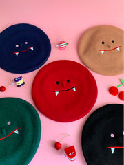 "Sharptooth" embroidered design beret, by Natali Koromoto Martinez.
