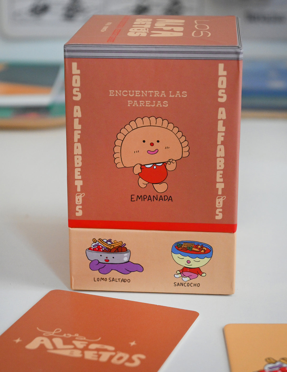 "Los Alfabetos" is a memory card matching game set of 26 pairs of Latin food characters. Designed by illustrator Natalí Koromoto Martínez.