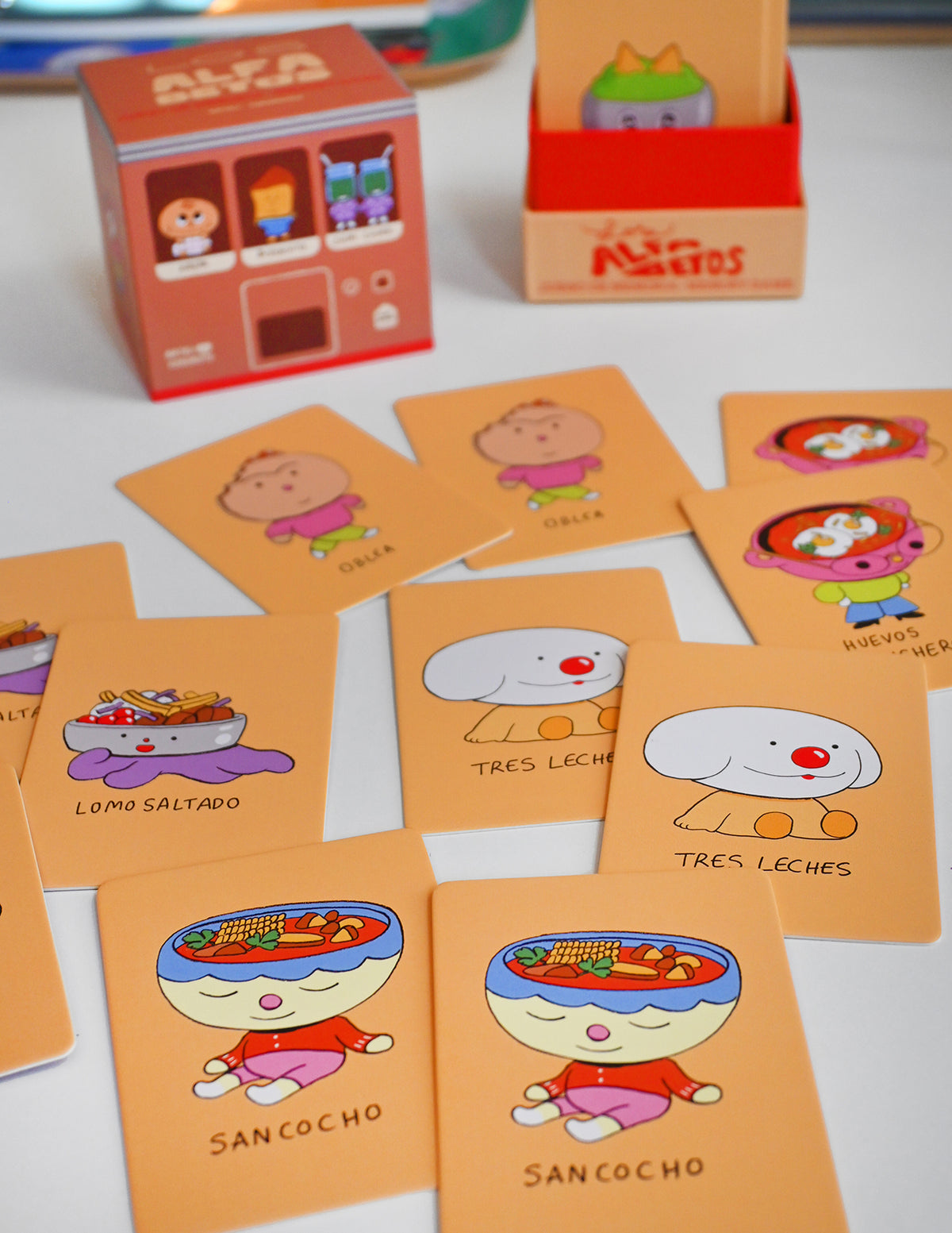 "Los Alfabetos" is a memory card matching game set of 26 pairs of Latin food characters. Designed by illustrator Natalí Koromoto Martínez.