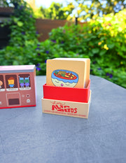 "Los Alfabetos" is a memory card matching game set of 26 pairs of Latin food characters. Designed by illustrator Natalí Koromoto Martínez.