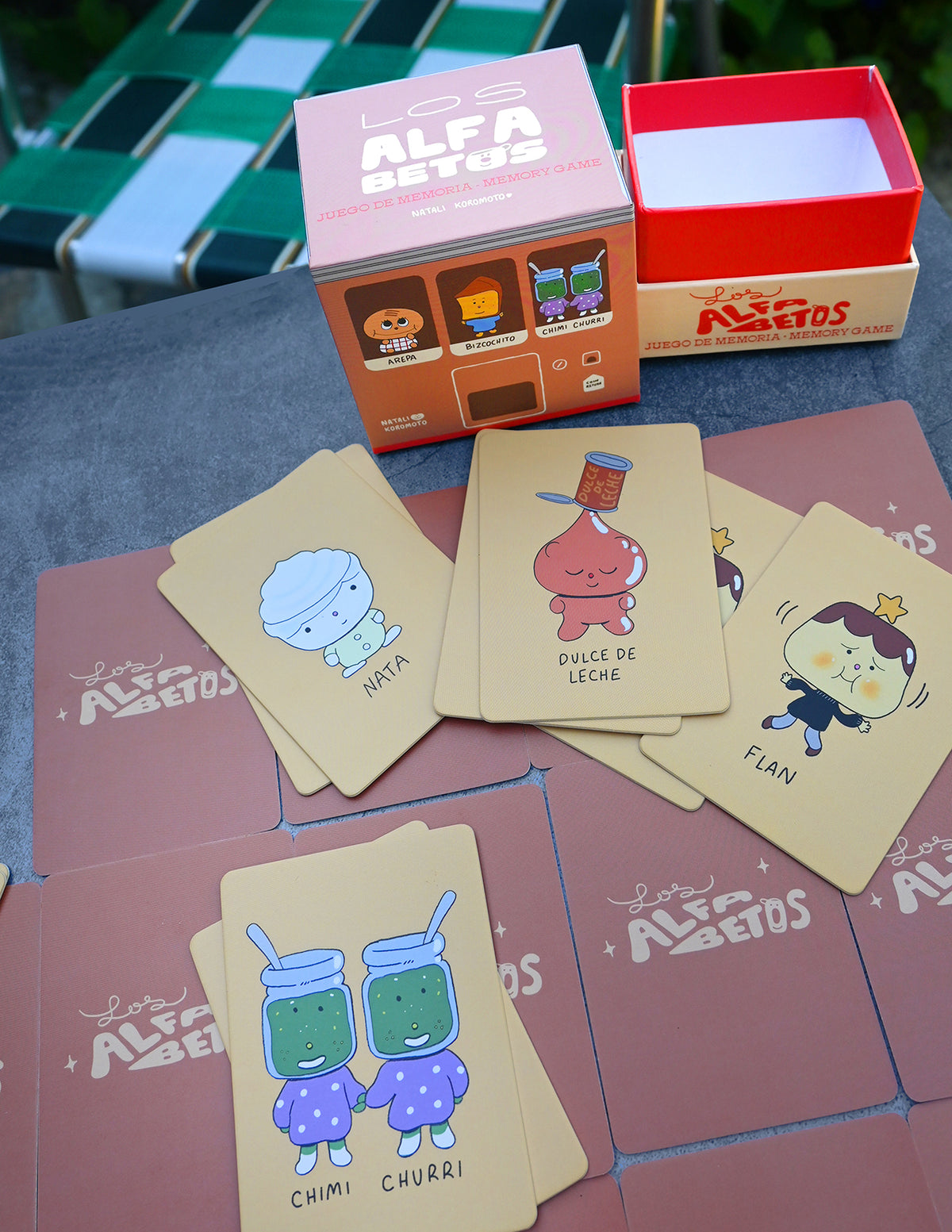 "Los Alfabetos" is a memory card matching game set of 26 pairs of Latin food characters. Designed by illustrator Natalí Koromoto Martínez.