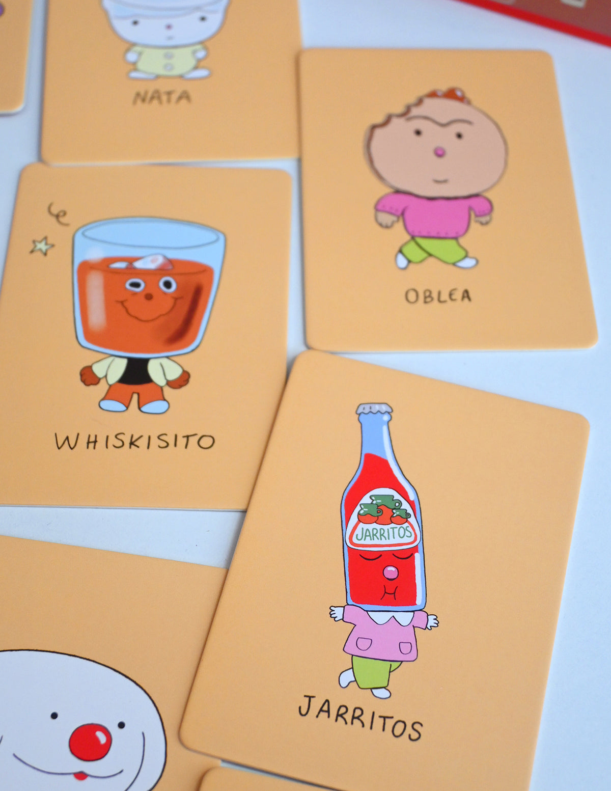 "Los Alfabetos" is a memory card matching game set of 26 pairs of Latin food characters. Designed by illustrator Natalí Koromoto Martínez.
