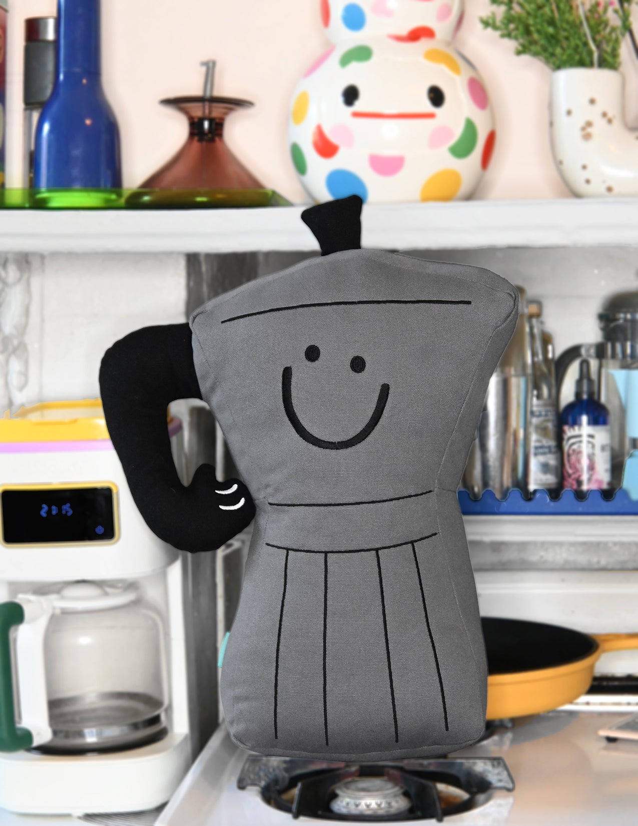 Throw pillow: Smiling espresso percolator character with thumbs up handle for an arm. Design by illustrator Natali Koromoto.