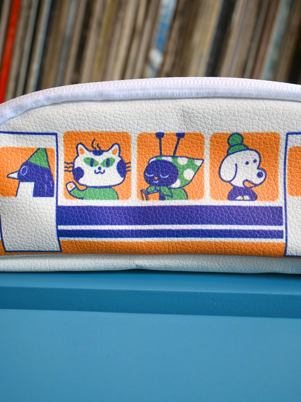 "Passengers" pencil pouch by Natali Koromoto showing full side view with printed animal characters enjoying their adventure on the Shinkansen bullet train.