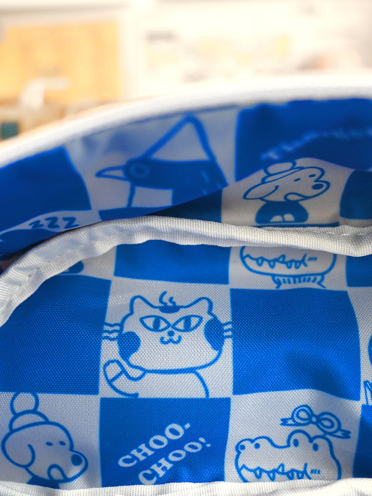Blue and white checkered fabric with cartoon animal designs and 'Choo Choo!' text.