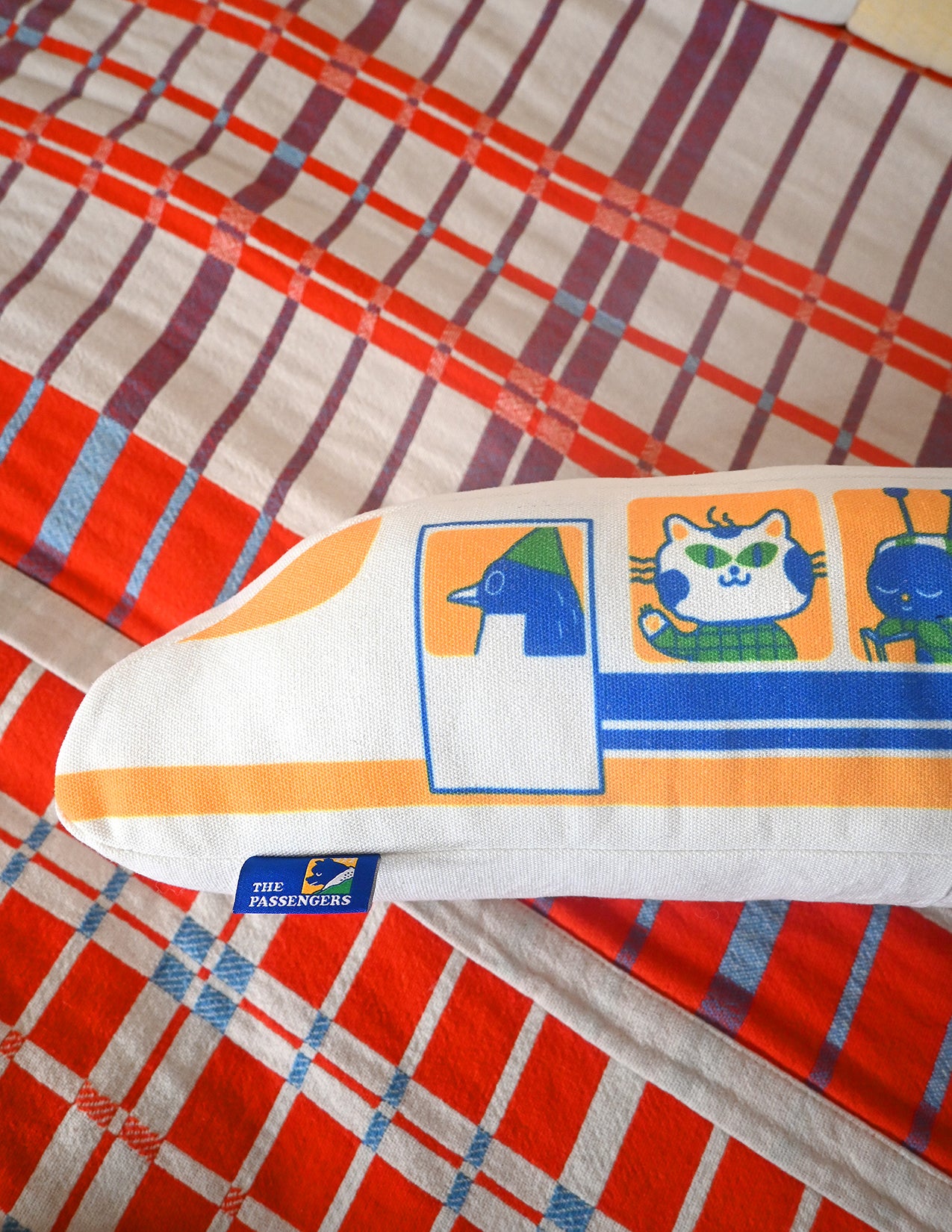 "The Passengers" throw pillow by Natali Koromoto. Showing full side view with animal characters enjoying their adventure on the Shinkansen bullet train.