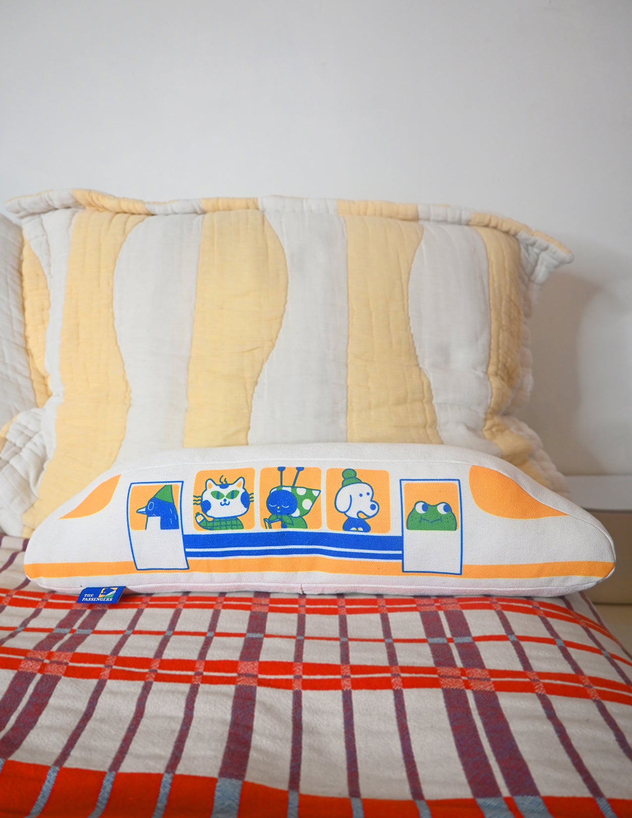 "The Passengers" throw pillow by Natali Koromoto. Showing full side view with animal characters enjoying their adventure on the Shinkansen bullet train.