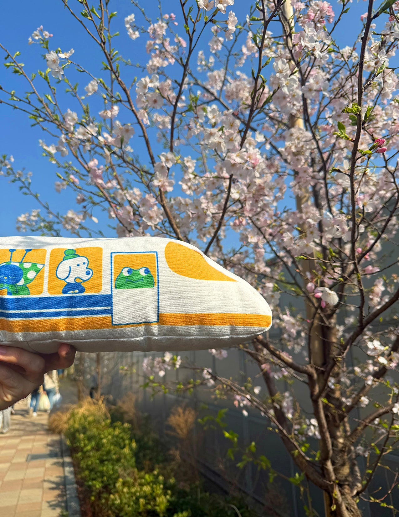 "The Passengers" throw pillow by Natali Koromoto. Showing full side view with animal characters enjoying their adventure on the Shinkansen bullet train.