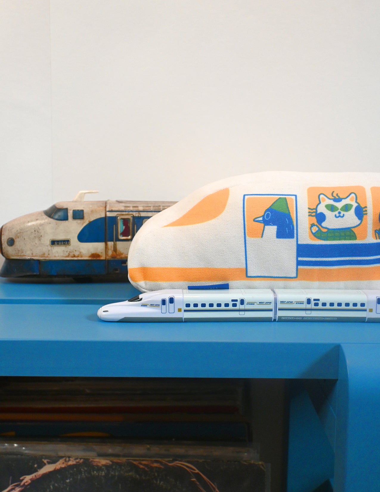 "The Passengers" throw pillow by Natali Koromoto. Showing full side view with animal characters enjoying their adventure on the Shinkansen bullet train.